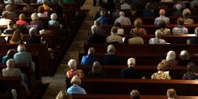 Audience listening attentively during a funeral speech.