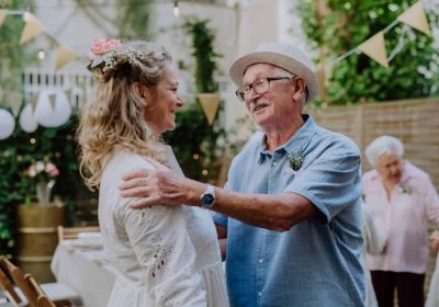 Elderly man giving a heartfelt speech at a wedding reception.